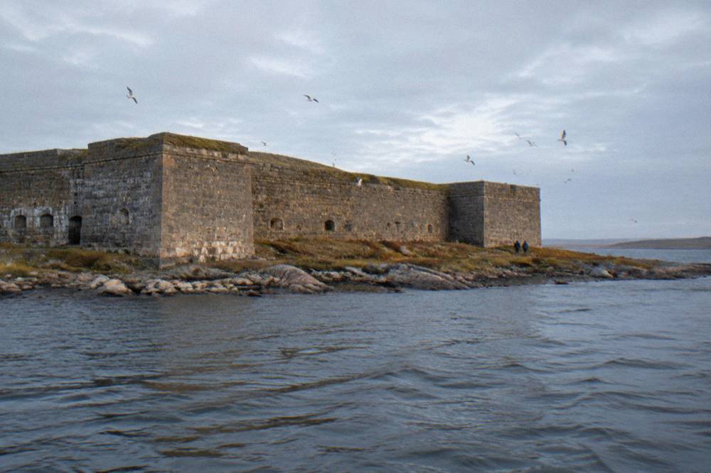 Historic stone walls of Prince of Wales Fort across the river with tundra and sea beyond