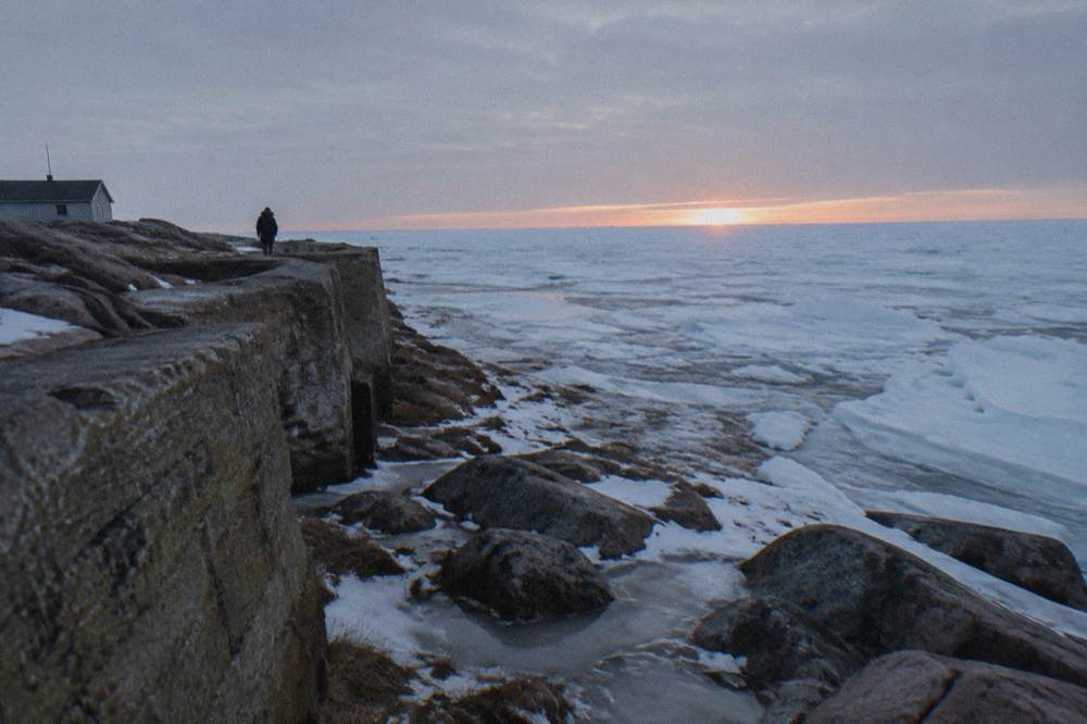 New sea ice spreading across Hudson Bay from the shoreline near Churchill under low winter light